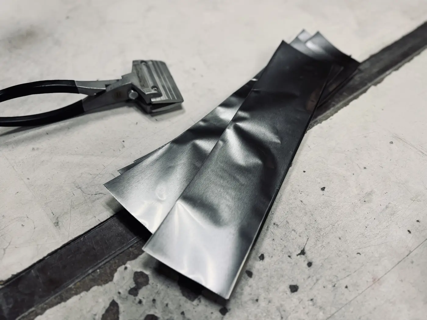 Knife blade sealed in an Inkonel foil bag after quench at Medford Knife