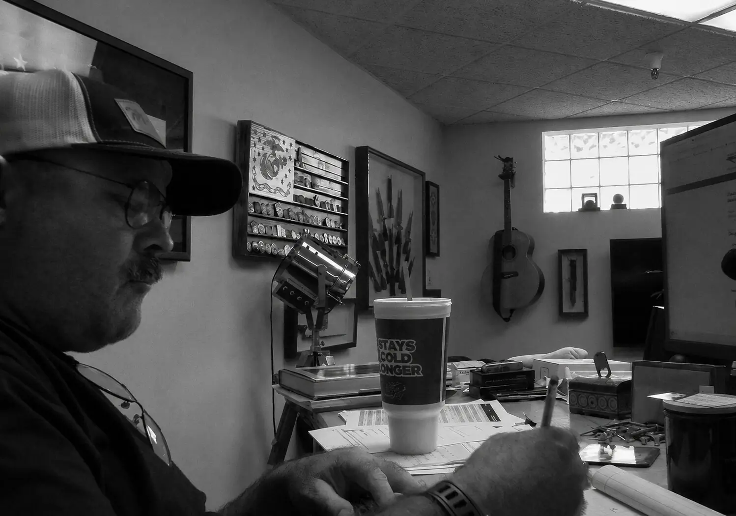 MKT knife designer sketching at a workbench