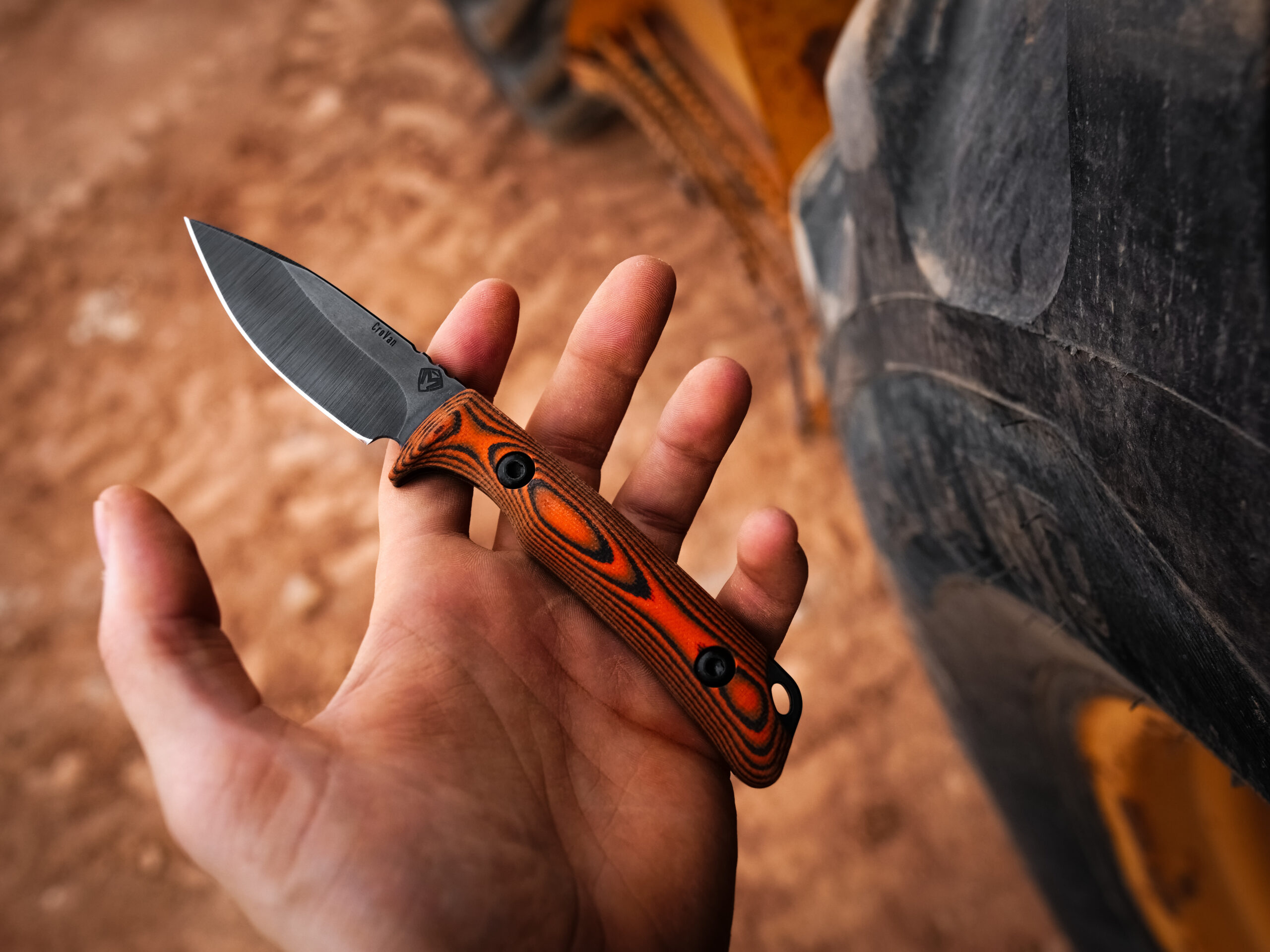 Spear Point Taskmaster held in hand outdoors.